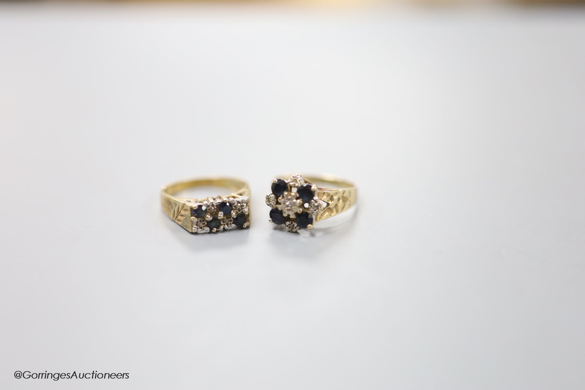 Two modern 9ct gold, sapphire and diamond chip set cluster rings